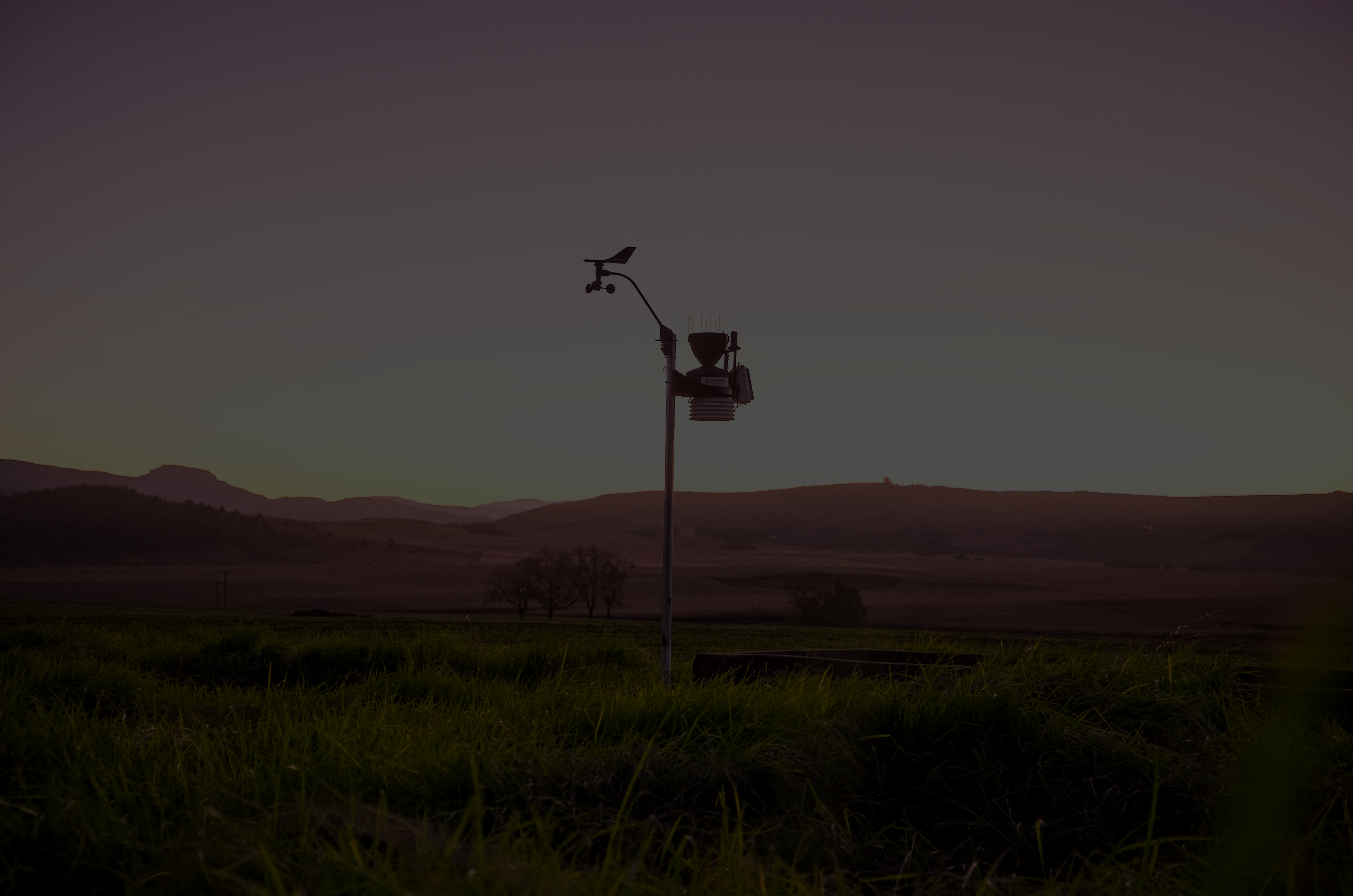 A vast landscape with a weather station with black overlay.